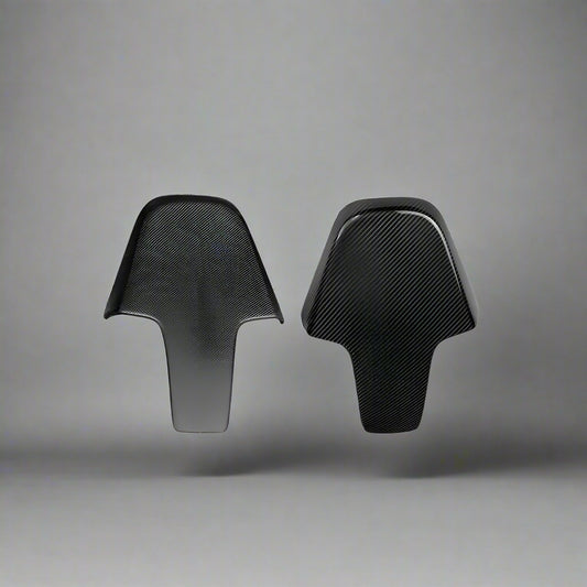 Two black carbon fiber seat covers on a white background