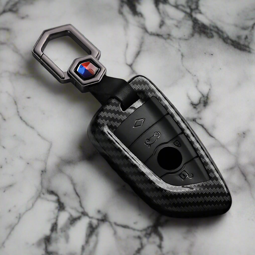 Carbon fiber key fob cover with brand logo on a black and white background