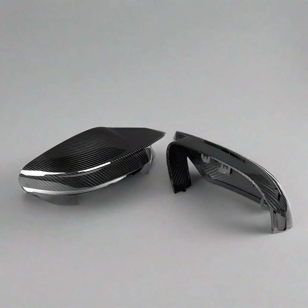 Carbon fiber car mirror cover on a white background