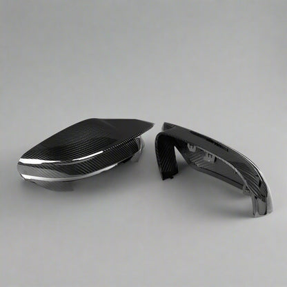 Carbon fiber car mirror cover on a white background