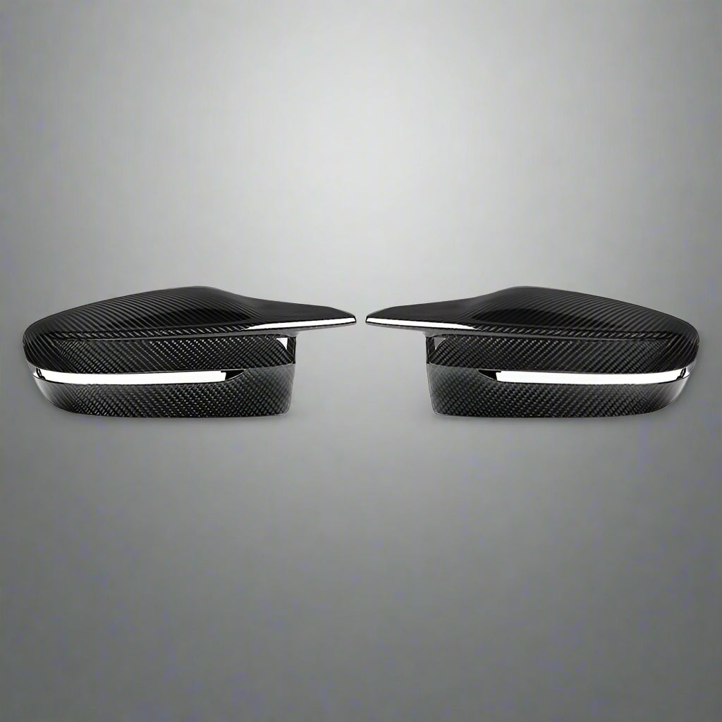 Two black carbon fiber car side mirrors on a white background