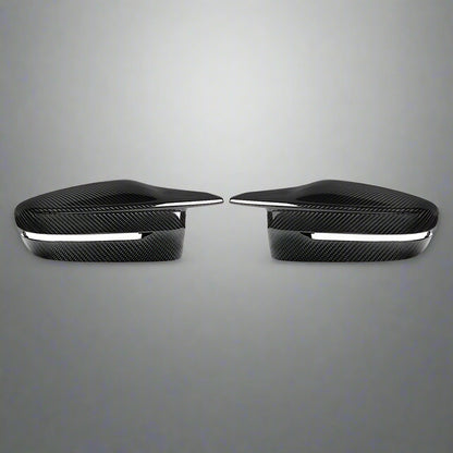 Two black carbon fiber car side mirrors on a white background